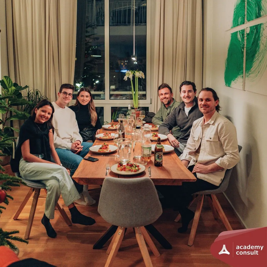 A group of people sitting around dinner table